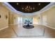Spacious clubhouse lobby featuring a grand chandelier, tile flooring, and elegant decor at 18186 Sandy Pointe Dr, Tampa, FL 33647