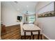Open concept dining room featuring wood floors, neutral walls, and abundant natural light at 18186 Sandy Pointe Dr, Tampa, FL 33647