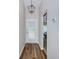 Entryway with wood floors, a glass-paned door, a decorative light fixture, and view into the living area at 18186 Sandy Pointe Dr, Tampa, FL 33647