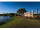 Entrance to Heritage Isles Golf & Country Club, with a serene lake and lush landscaping at 18186 Sandy Pointe Dr, Tampa, FL 33647