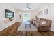 Spacious living room featuring modern wood floors, neutral walls, and sliding glass doors to the pool at 18186 Sandy Pointe Dr, Tampa, FL 33647