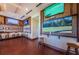 Comfortable lounge with dark wood floors, cushioned stools and several televisions mounted on paneled walls at 18186 Sandy Pointe Dr, Tampa, FL 33647