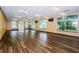 Expansive dance studio with hardwood floors, large windows providing natural light and wall mounted TV at 18186 Sandy Pointe Dr, Tampa, FL 33647