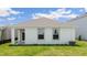 View of the home's backyard showcasing well-maintained landscaping, and a neutral exterior in a desirable community at 1828 Cobb Trl, Parrish, FL 34219