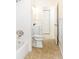 Traditional bathroom featuring a tub, toilet, sink, and neutral tile flooring at 184 Garden Nw Ave, Port Charlotte, FL 33952