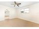 Bright bedroom features neutral walls, tiled floors, a ceiling fan, and natural light from a window at 184 Garden Nw Ave, Port Charlotte, FL 33952