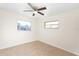 Bedroom featuring tile floors, ceiling fan, and natural light from two windows at 184 Garden Nw Ave, Port Charlotte, FL 33952