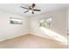 Bright bedroom featuring tile floors, ceiling fan and two windows at 184 Garden Nw Ave, Port Charlotte, FL 33952