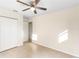 Bedroom featuring tile flooring, ceiling fan, closet, and access to other rooms at 184 Garden Nw Ave, Port Charlotte, FL 33952