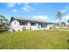 Charming single-story home with a well-maintained lawn and inviting blue front door at 184 Garden Nw Ave, Port Charlotte, FL 33952