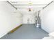 Spacious garage interior with white walls, grey floor, overhead door and mechanical components at 184 Garden Nw Ave, Port Charlotte, FL 33952