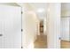 Hallway featuring neutral paint, tile floors, and access to the kitchen at 184 Garden Nw Ave, Port Charlotte, FL 33952