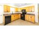 Charming kitchen featuring wooden cabinets, granite countertops and black appliances at 184 Garden Nw Ave, Port Charlotte, FL 33952