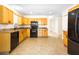 Charming kitchen featuring wooden cabinets, granite countertops and black appliances at 184 Garden Nw Ave, Port Charlotte, FL 33952