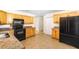 Bright kitchen features wooden cabinets, granite countertops, and black appliances at 184 Garden Nw Ave, Port Charlotte, FL 33952