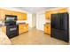 Bright kitchen features wooden cabinets, granite countertops, and black appliances at 184 Garden Nw Ave, Port Charlotte, FL 33952