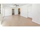 Open living area featuring neutral tile floors, ceiling fan, and access to the kitchen at 184 Garden Nw Ave, Port Charlotte, FL 33952