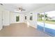 Spacious living room with tile floors, skylight and sliding door access to the pool at 184 Garden Nw Ave, Port Charlotte, FL 33952