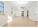 Bright living room with tile floors, skylight, ceiling fan and access to other rooms at 184 Garden Nw Ave, Port Charlotte, FL 33952