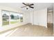 Bright living room with ceiling fan, large windows letting in natural light, and neutral tile floors at 184 Garden Nw Ave, Port Charlotte, FL 33952
