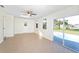 Bright living room with tile floors, skylight, ceiling fan and access to the pool area at 184 Garden Nw Ave, Port Charlotte, FL 33952