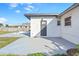 View of the back patio, with door and window, in addition to the Kidney-shaped pool and part of the backyard at 184 Garden Nw Ave, Port Charlotte, FL 33952