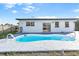 Backyard view showcasing the pool, patio, and exterior of the home with windows and sliding glass doors at 184 Garden Nw Ave, Port Charlotte, FL 33952