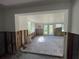 Living room interior with exposed wall framing, open to back yard, and visible back yard view at 1924 45Th Street E Ct, Bradenton, FL 34208