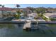 Waterfront home with boat dock and lift, featuring a private pool and lush tropical landscaping at 1984 Kansas Ne Ave, St Petersburg, FL 33703