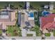 Stunning aerial view of waterfront property with private pool, boat dock, and lush tropical landscaping at 1984 Kansas Ne Ave, St Petersburg, FL 33703