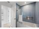 Bathroom featuring blue tile accent, modern shower head, and neutral floors at 1984 Kansas Ne Ave, St Petersburg, FL 33703