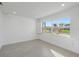 Bright bedroom featuring laminate floors and a large window with shutters at 1984 Kansas Ne Ave, St Petersburg, FL 33703