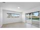 Bright bedroom with sliding glass door access to the pool, scenic view, and neutral tones at 1984 Kansas Ne Ave, St Petersburg, FL 33703