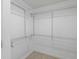Walk-in closet with white wire shelving and laminate floors at 1984 Kansas Ne Ave, St Petersburg, FL 33703