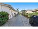 Functional side yard with a brick path, mature landscaping, and privacy fencing, blending practicality and charm at 1984 Kansas Ne Ave, St Petersburg, FL 33703