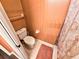 Functional bathroom with a white toilet, tiled floor, and striped walls at 1988 Georgia S Cir, Clearwater, FL 33760