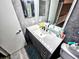 This bathroom features a granite vanity, a large mirror and tile flooring at 1988 Georgia S Cir, Clearwater, FL 33760