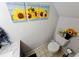 Bright, cheerful bathroom with sunflower decor and tile flooring at 1988 Georgia S Cir, Clearwater, FL 33760