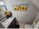 Bathroom featuring granite counters and sunflower decor at 1988 Georgia S Cir, Clearwater, FL 33760