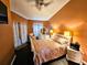 Spacious bedroom featuring dark laminate flooring, a ceiling fan, and lots of natural light at 1988 Georgia S Cir, Clearwater, FL 33760
