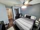 Bedroom boasts a ceiling fan, hardwood floors, a closet and serene neutral color at 1988 Georgia S Cir, Clearwater, FL 33760