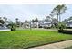 A manicured lawn in a townhouse community with mature trees at 1988 Georgia S Cir, Clearwater, FL 33760
