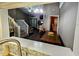 View of the dining room with an attached sitting area and open staircase at 1988 Georgia S Cir, Clearwater, FL 33760