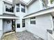 The exterior of the home is painted white and features a covered entry and manicured landscaping at 1988 Georgia S Cir, Clearwater, FL 33760