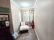 Cozy hallway nook with a comfortable chair, warm lighting, and decorative accents at 1988 Georgia S Cir, Clearwater, FL 33760