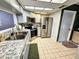 Modern kitchen with stainless steel appliances, granite countertops and tiled floors at 1988 Georgia S Cir, Clearwater, FL 33760