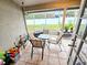 The screened patio features tile flooring, seating, and views of the backyard at 1988 Georgia S Cir, Clearwater, FL 33760