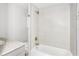 A bright bathroom featuring tiled walls, a bathtub, and a neutral-toned vanity with a marble countertop at 200 S Bayshore Blvd, Clearwater, FL 33759