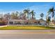 Charming single-story home surrounded by lush greenery, palm trees and a picket fence at 200 S Bayshore Blvd, Clearwater, FL 33759