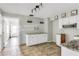 This charming kitchen features white cabinets, granite countertops, and tile flooring at 200 S Bayshore Blvd, Clearwater, FL 33759